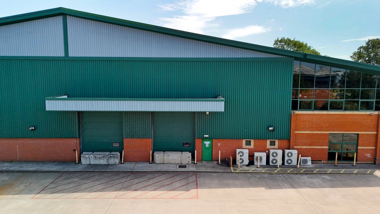 The green clad elevation and surface level loading doors