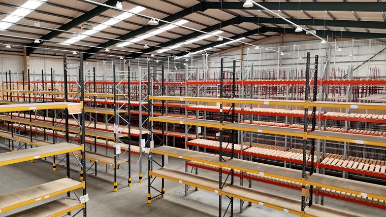 The warehouse seen from the mezzanine, racking below