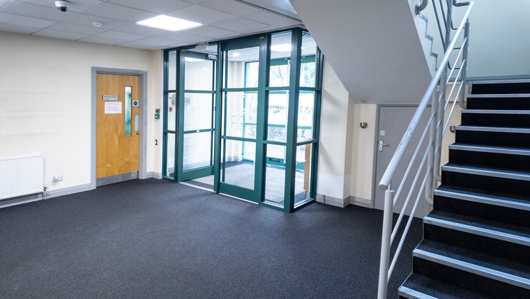 A reception area with the staircase to the first floor