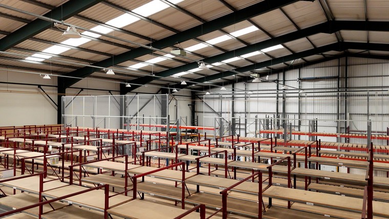 The mezzanine deck seen along its length beneath the warehouse roof lights